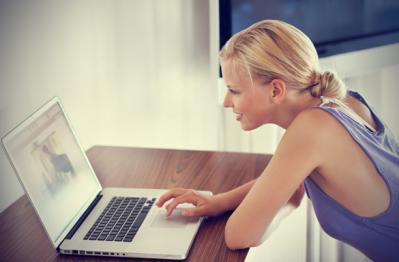 Blonde woman working on her laptop from home 5