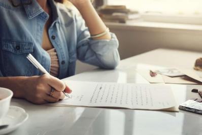 Woman writing letter envelope