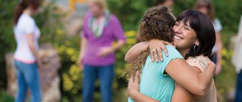 Women hugging at womens ministry